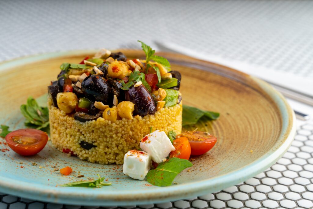 Couscous with vegetables and feta on a plate
