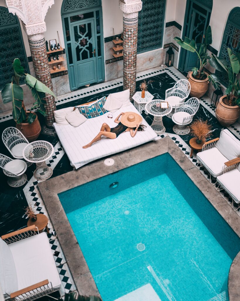 Woman relaxing near the pool in Moroccan luxury hotel