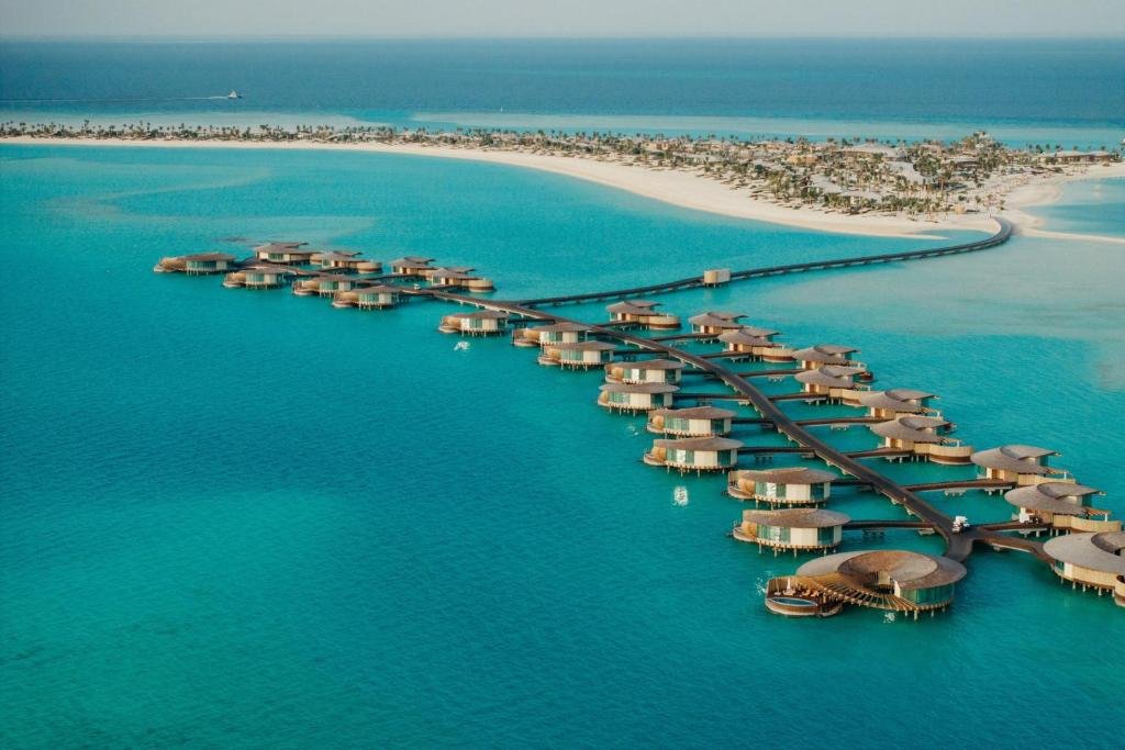 Aerial view of St. Regis Red Sea Resort villas over bright turquoise water in Saudi Arabia