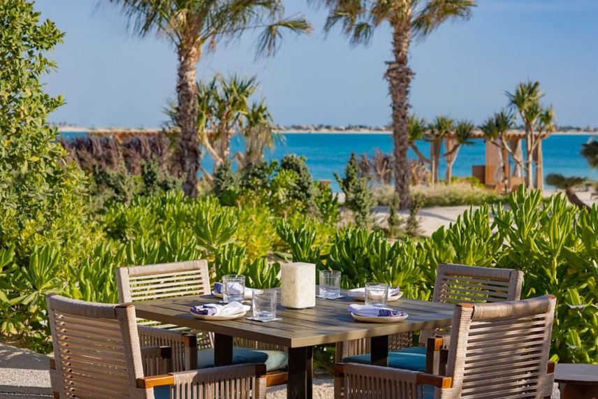 Outdoor dining area at the Beach Club at St. Regis Red Sea Resort