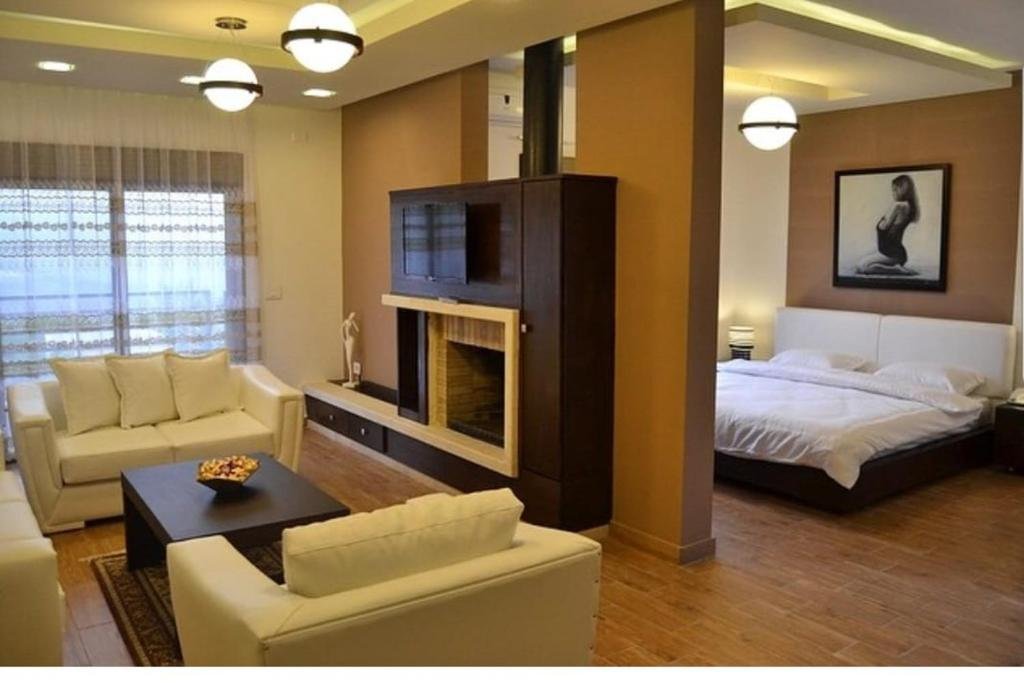Serail Hotel room in Ehden with bed, seating area, and warm interior decor