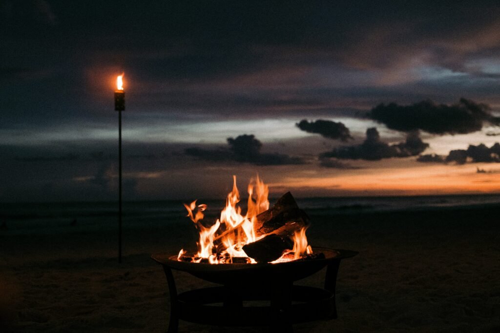 Sunset bonfires on a secluded beach in Dubai