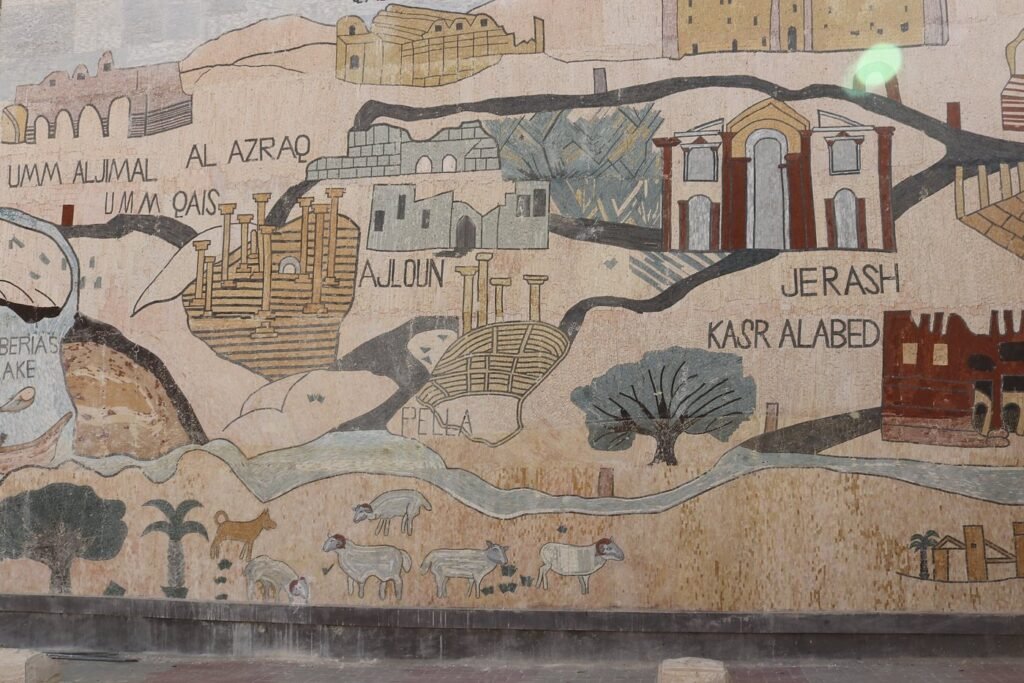 The colorful wall mural decorating the parking lot of Madaba Visitors Centre