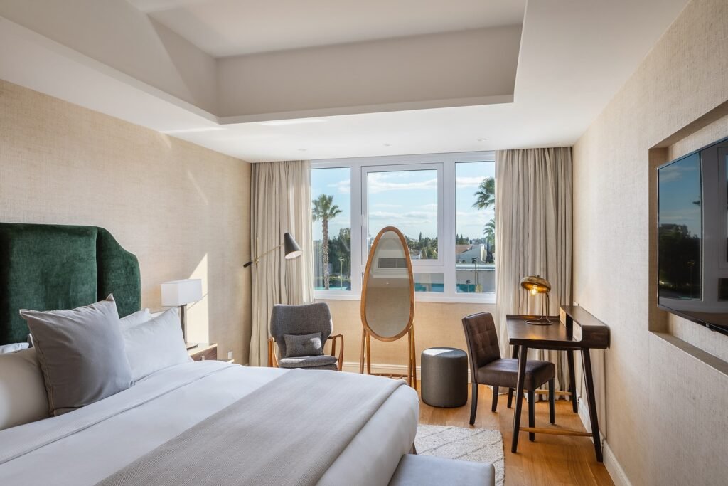 Guest room at Hilton Nicosia with large bed, soft tones, and natural light