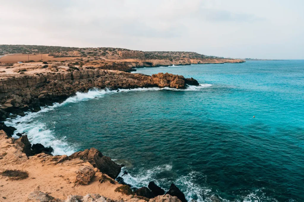 Blue Lagoon at Cape Greco with bright turquoise water and rocky coastline
