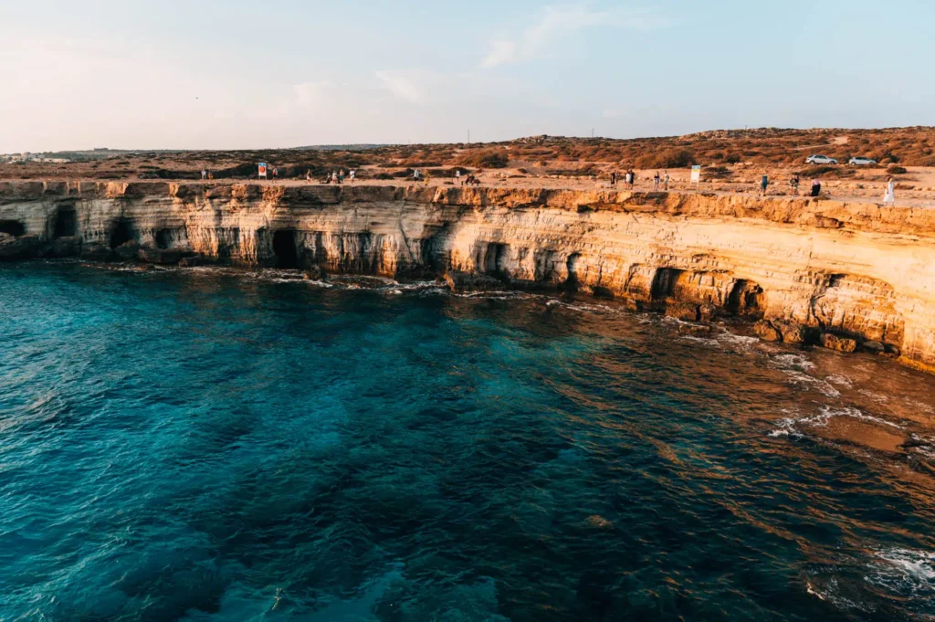 Sea Caves at Cape Greco near Ayia Napa with rocky cliffs and blue water