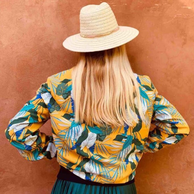 Woman in colourful shirt and hat
