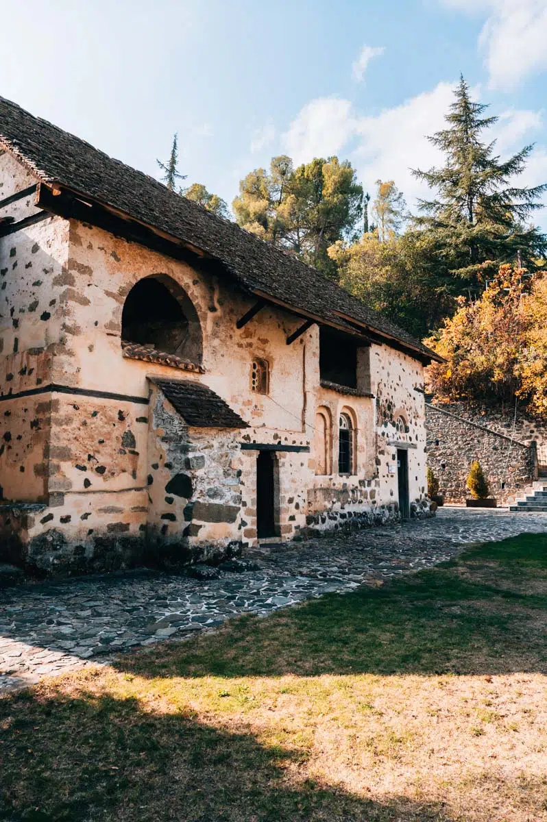 Agios Ioannis Lampadistis church in Kalopanayiotis with stone courtyard and barn roof architecture