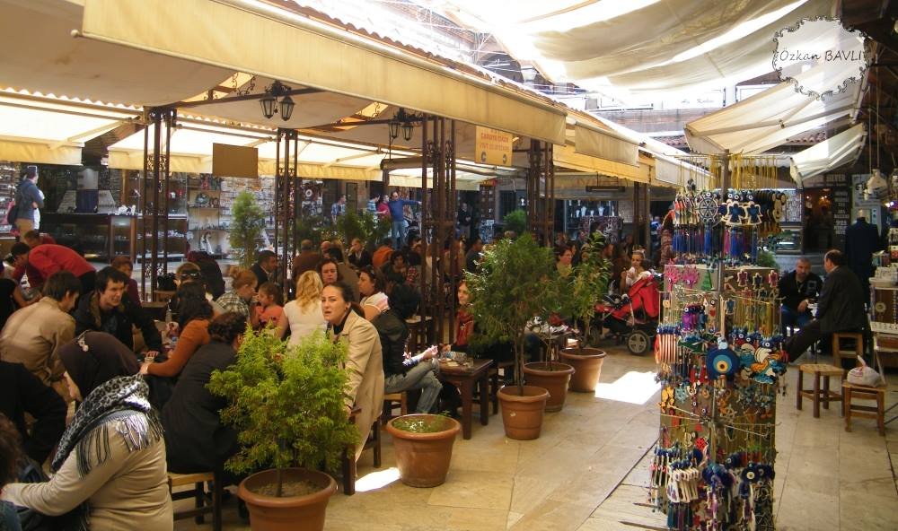 Interior courtyard of historic Kızlarağası Inn in Izmir with small shops and arches
