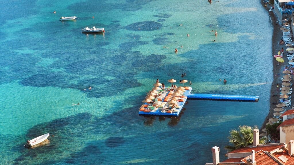 Mimosa Bay in Karaburun with calm blue water and pebble beach