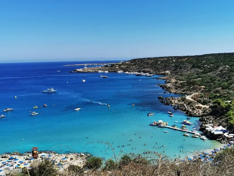 Konnos Bay near Cape Greco with turquoise water beneath pine-covered hills
